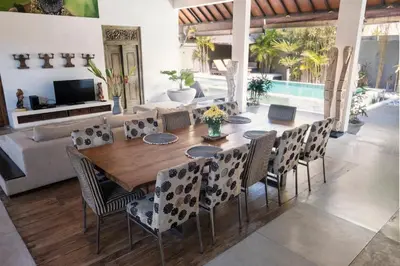 a dining room with a wooden table and chairs at Seminyak Villa in Seminyak