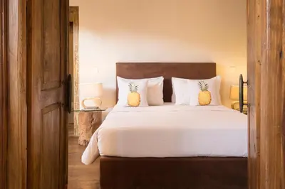 a bedroom with a bed with two pineapple pillows at Seminyak Villa in Seminyak