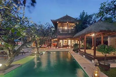 a house with a swimming pool in front of a house at Luxury 6-bedroom Villa in Seminyak in Seminyak