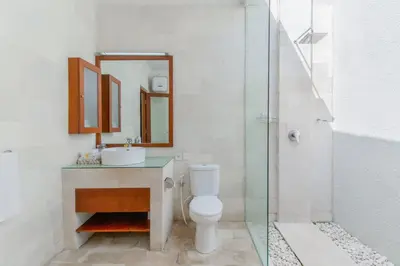 a bathroom with a toilet and a sink and a shower at Heart of Seminyak, 2Br, Sleeps 4, Walk to Bintang in Seminyak
