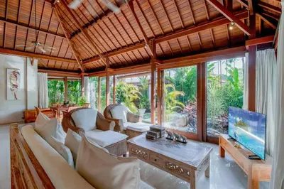 a living room with a couch and a tv at Heart of Seminyak, 2Br, Sleeps 4, Walk to Bintang in Seminyak