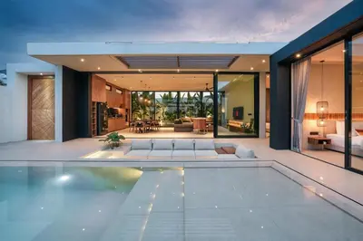 a house with a swimming pool and a living room at Villa Dorithis Umalas in Kerobokan