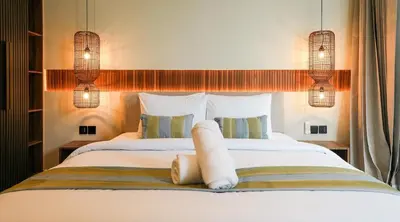 a bedroom with a large bed with two pillows at Villa Dorithis Umalas in Kerobokan