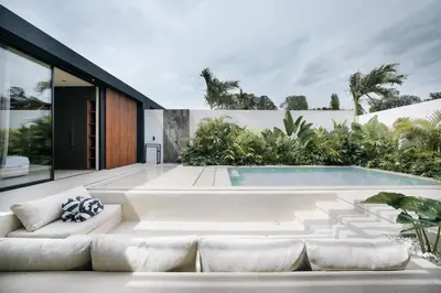 a swimming pool in the backyard of a house at Villa Dorithis Umalas in Kerobokan