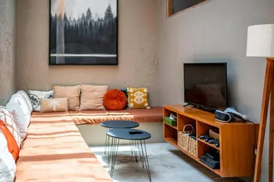 a living room with a couch and a television at Villa Tanaka Spacious Family Villa Berawa in Canggu