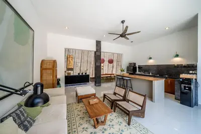 a living room with a couch and a table at Villa Tanaka Spacious Family Villa Berawa in Canggu