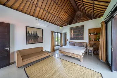 a bedroom with a bed and a couch at Villa Tanaka Spacious Family Villa Berawa in Canggu