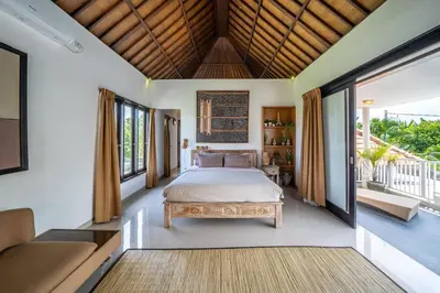 a bedroom with a bed and a couch at Villa Tanaka Spacious Family Villa Berawa in Canggu