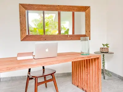 an office with a wooden desk with a laptop on it at Umalas cozy 3 Bedrooms private pool villa in Kerobokan