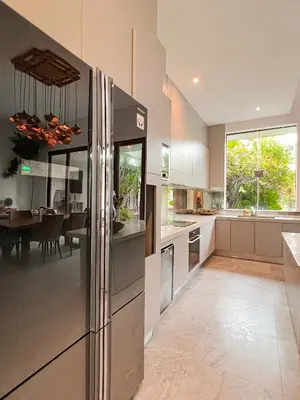 a kitchen with a refrigerator and a dining room at Umalas cozy 3 Bedrooms private pool villa in Kerobokan