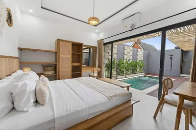 a bedroom with a bed and a swimming pool at Nara V3 2BR Escape in the Heart of Seminyak in Seminyak