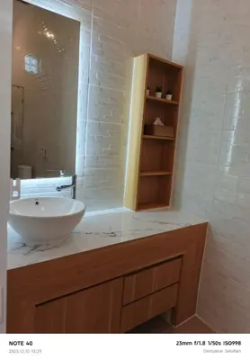 a bathroom with a sink and a mirror at Khrisna Sanur Villa in Pesanggaran