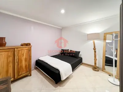 a bedroom with a bed and a lamp in a room at Strategic 2BR Seminyak House UP2 6 Person in Seminyak