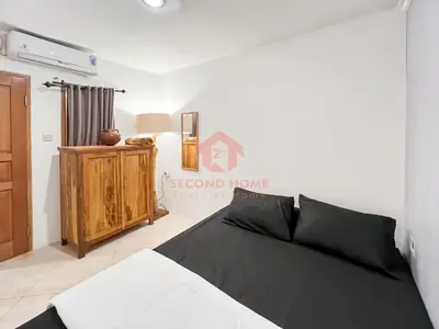 a bedroom with a bed and a dresser in a room at Strategic 2BR Seminyak House UP2 6 Person in Seminyak
