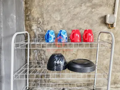 a shelf with a group of bowls and plates at Strategic 2BR Seminyak House UP2 6 Person in Seminyak