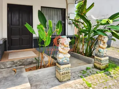 a pair of statues in front of a house at Strategic 2BR Seminyak House UP2 6 Person in Seminyak
