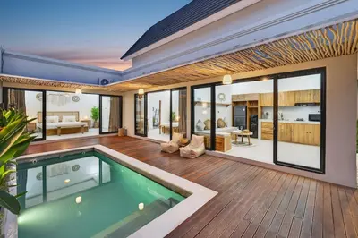 a house with a swimming pool and a living room at Nara V11 2BR Escape in the Heart of Seminyak in Seminyak