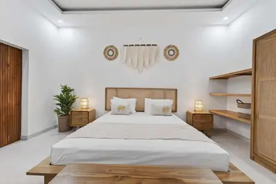 a bedroom with a large bed and two night stands at Nara V11 2BR Escape in the Heart of Seminyak in Seminyak