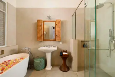 a bathroom with a tub and a sink and a shower at Dulcinea Spacious 5 BR Private Pool Villa in Jimbaran