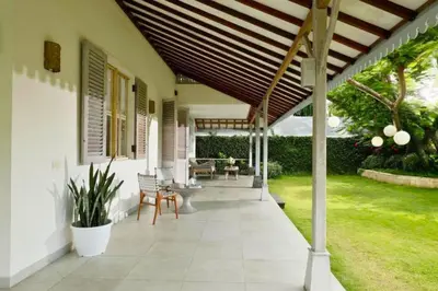 a porch of a house with a wooden pergola at Dulcinea Spacious 5 BR Private Pool Villa in Jimbaran