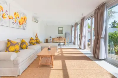 a living room with a white couch and a table at Dulcinea Spacious 5 BR Private Pool Villa in Jimbaran