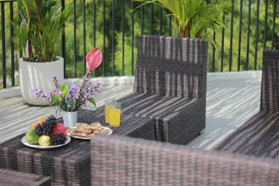a table and chairs with a plate of fruit and juice at Uma 2 BR villa with Roof top pool & Enclosed living room in Seminyak