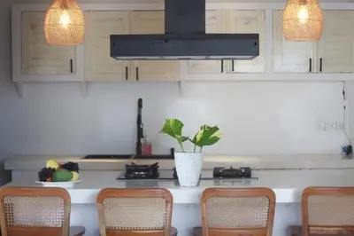 a kitchen with a table with a potted plant on it at Uma 2 BR villa with Roof top pool & Enclosed living room in Seminyak