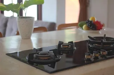 a stove top with a vase on a kitchen counter at Uma 2 BR villa with Roof top pool & Enclosed living room in Seminyak