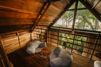 an attic room with two elephants and a window at Wow Cozy Lagoon! in Nusa Dua