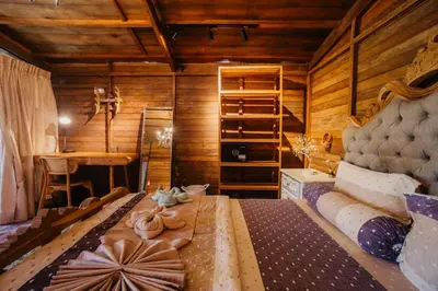 a bedroom with a large bed and a desk at Wow Cozy Lagoon! in Nusa Dua