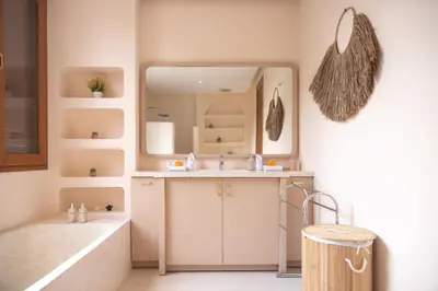 a bathroom with a sink and a mirror at Luxury 3BR Canggu | Billiards | Outdoor Cinema in Canggu