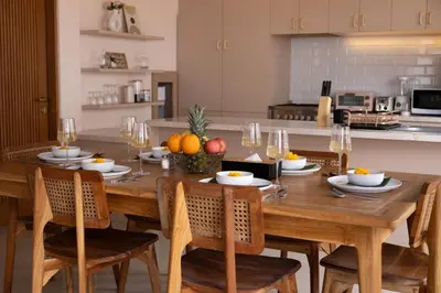 a kitchen with a wooden table with fruit on it at Luxury 3BR Canggu | Billiards | Outdoor Cinema in Canggu