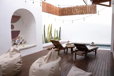 a living room with chairs and a table and cactus at Luxury 3BR Canggu | Billiards | Outdoor Cinema in Canggu
