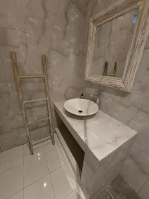 a bathroom with a sink and a mirror at Happy's house Bali in Kerobokan