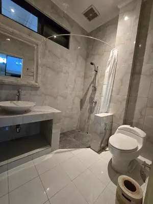 a bathroom with a toilet and a sink and a shower at Happy's house Bali in Kerobokan