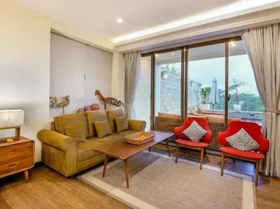 a living room with a couch and two red chairs at villa dreamland beach 300 meter private walk in Jimbaran