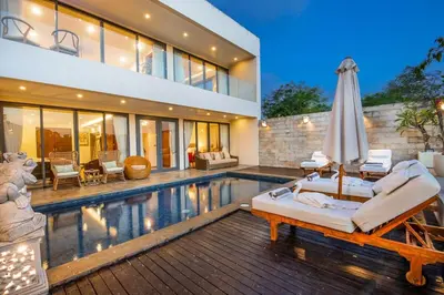 a home with a swimming pool and a house at villa dreamland beach 300 meter private walk in Jimbaran