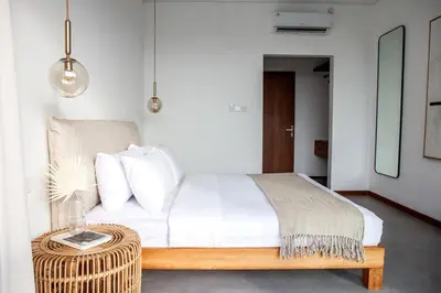 a bedroom with a bed and a rattan table at Villa Kenia 1 in Umalas, near Canggu in Canggu