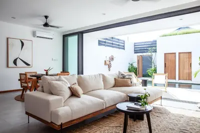 a living room with a white couch and a table at Villa Kenia 1 in Umalas, near Canggu in Canggu