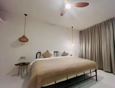 a bedroom with a bed and a ceiling fan at Dakings Greece House in Legian
