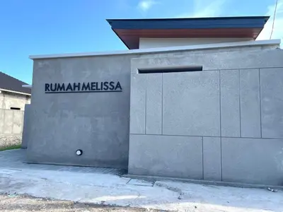 a building with a sign on the side of it at Rumah Melissa - Modern Boho 3BR Brand New Villa in Sanur in Sanur