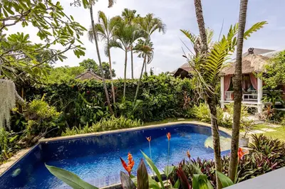 a swimming pool in a garden with palm trees at Charming, Homely, Pool, Lush Gardens, Umalas, Cozy in Kerobokan