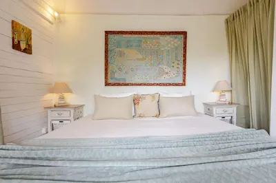 a bedroom with a large white bed with two night stands at Charming, Homely, Pool, Lush Gardens, Umalas, Cozy in Kerobokan
