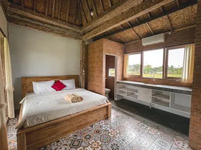 a bedroom with a bed and a sink in it at Balian Retreat Centre Homestay in Sanur