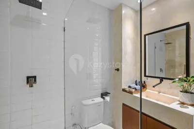 a bathroom with a toilet and a sink and a mirror at Kirelo Villa by Kozystay - Sanur in Sanur