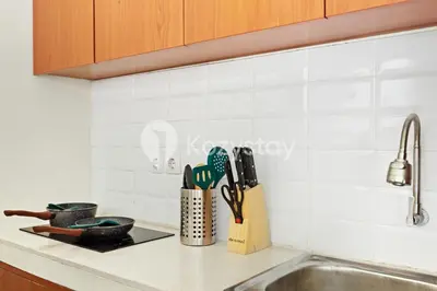 a kitchen counter with a sink and utensils at Kirelo Villa by Kozystay - Sanur in Sanur