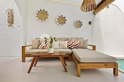 a living room with a couch and a table at Kirelo Villa by Kozystay - Sanur in Sanur