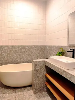 a bathroom with a tub and a sink at Coconut Villa in Kerobokan