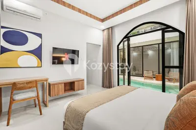 a bedroom with a bed and a desk at Sadin Villa by Kozystay - Umalas in Kerobokan