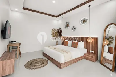 a bedroom with a bed and a mirror at Sadin Villa by Kozystay - Umalas in Kerobokan